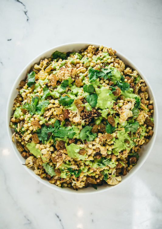 Spiced roasted cauliflower, green tahini, chickpeas, cous cous, pickled onion, pomegranate, coriander & roasted almonds